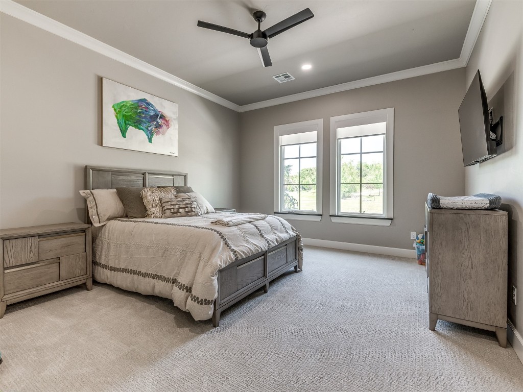 4324 Corridor Drive, Edmond, OK 73034 carpeted bedroom with ornamental molding and ceiling fan