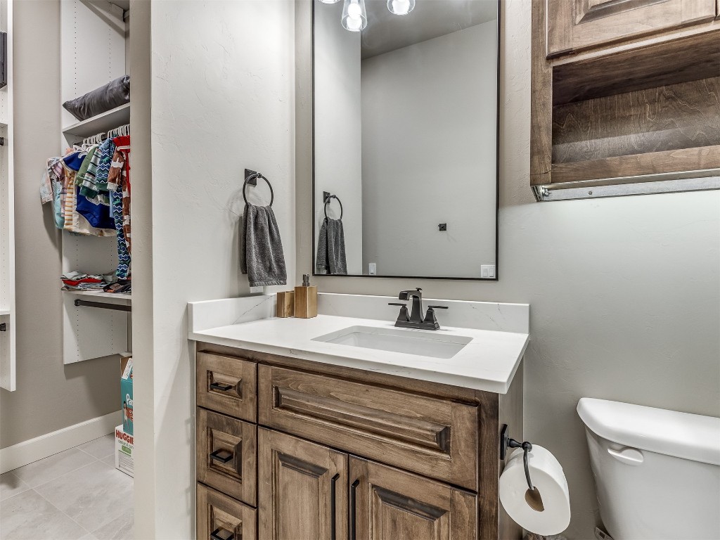 4324 Corridor Drive, Edmond, OK 73034 bathroom with toilet, tile floors, and vanity with extensive cabinet space