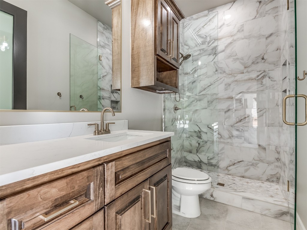 4324 Corridor Drive, Edmond, OK 73034 bathroom with an enclosed shower, toilet, tile flooring, and vanity