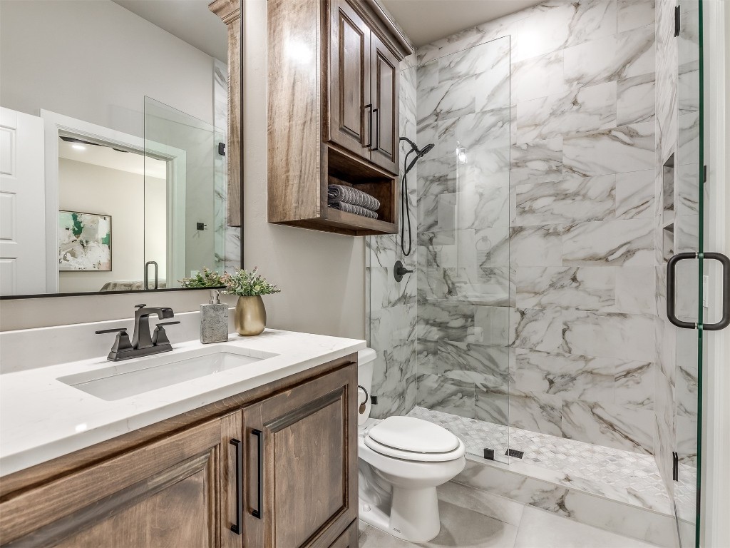 4324 Corridor Drive, Edmond, OK 73034 bathroom featuring tile flooring, vanity, toilet, and a shower with shower door