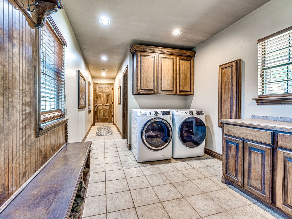 1580 NW 220th Street, Edmond, OK 73025 clothes washing area with cabinets, separate washer and dryer, plenty of natural light, and light tile floors