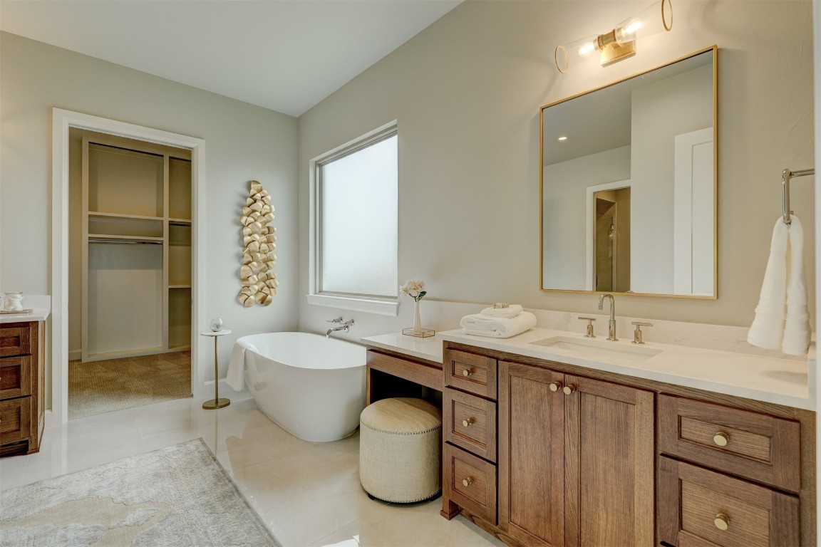 6416 NW 150th Terrace, Oklahoma City, OK 73142 bathroom with a washtub, tile floors, and vanity
