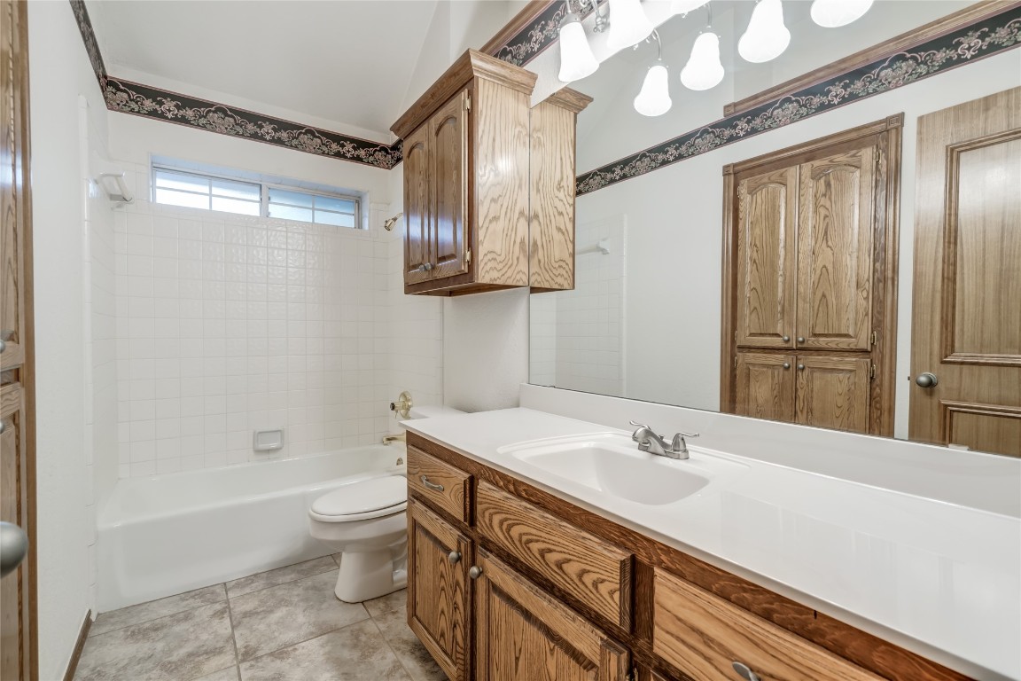 7416 NW 114th Terrace, Oklahoma City, OK 73162 full bathroom featuring shower / bath combination, toilet, tile floors, and large vanity