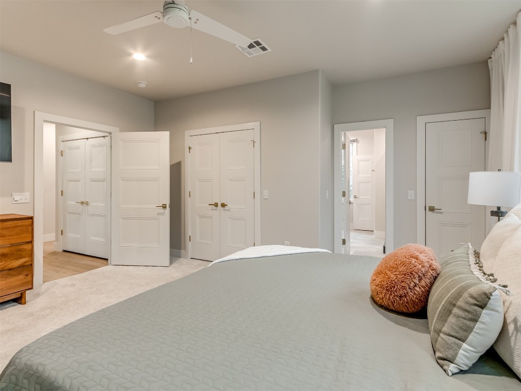 59 Redbud Street, Carlton Landing, OK 74432 carpeted bedroom featuring multiple closets and ceiling fan