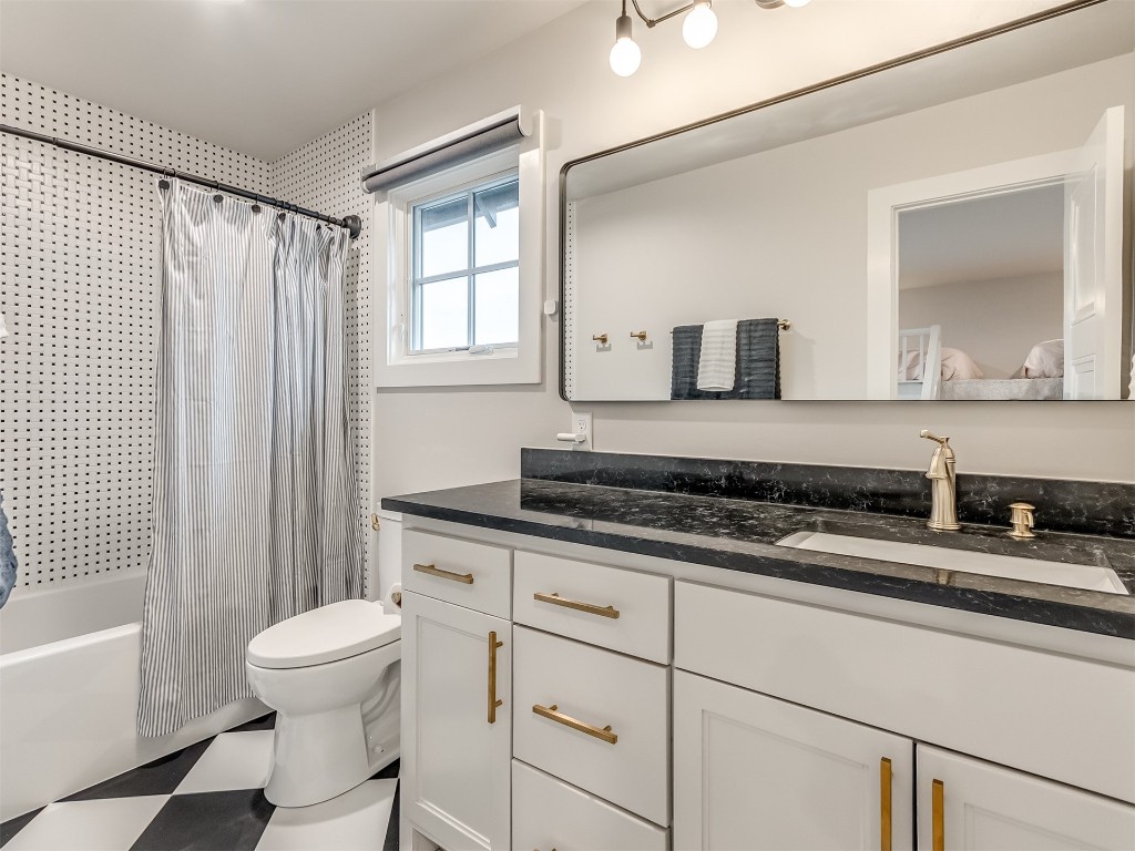 59 Redbud Street, Carlton Landing, OK 74432 full bathroom featuring vanity, toilet, tile flooring, and shower / bath combo with shower curtain