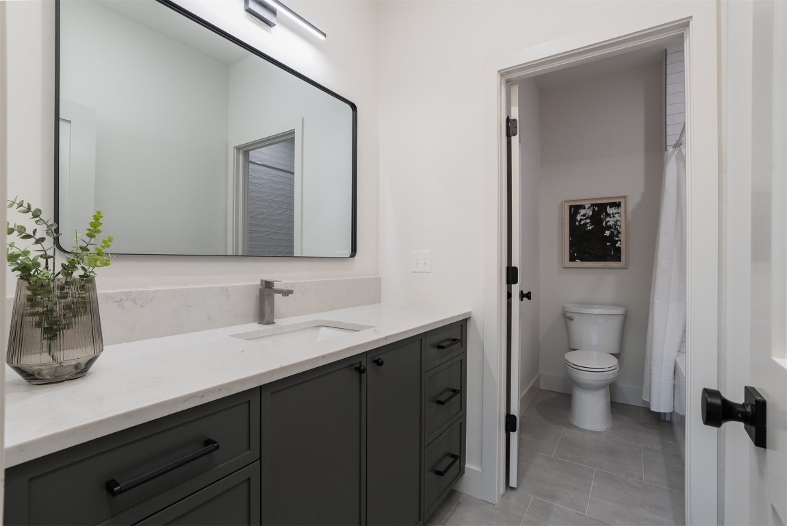 1209 NW 42nd Street, Oklahoma City, OK 73118 bathroom featuring vanity, toilet, and tile flooring