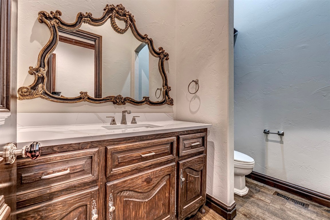 6516 NW Grand Boulevard, Nichols Hills, OK 73116 bathroom featuring wood-type flooring, toilet, and large vanity