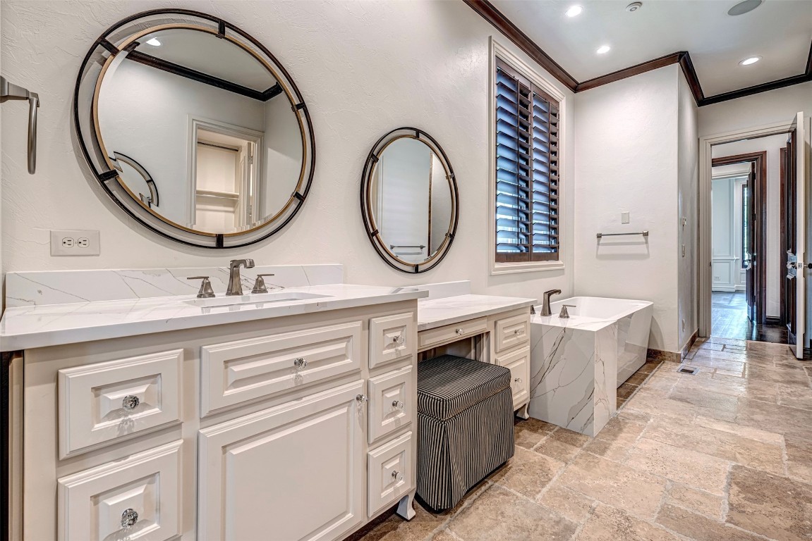 6516 NW Grand Boulevard, Nichols Hills, OK 73116 bathroom with vanity, a washtub, hardwood / wood-style flooring, and crown molding
