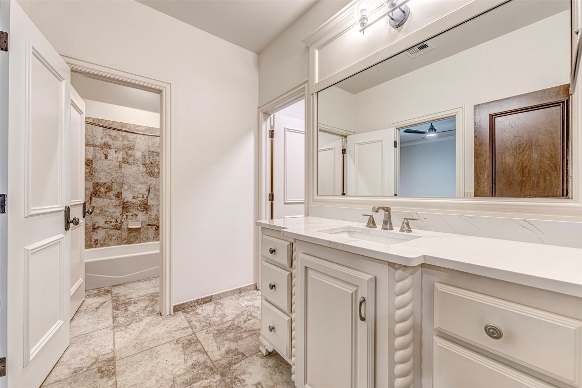6516 NW Grand Boulevard, Nichols Hills, OK 73116 bathroom with shower / bathing tub combination, tile flooring, and vanity
