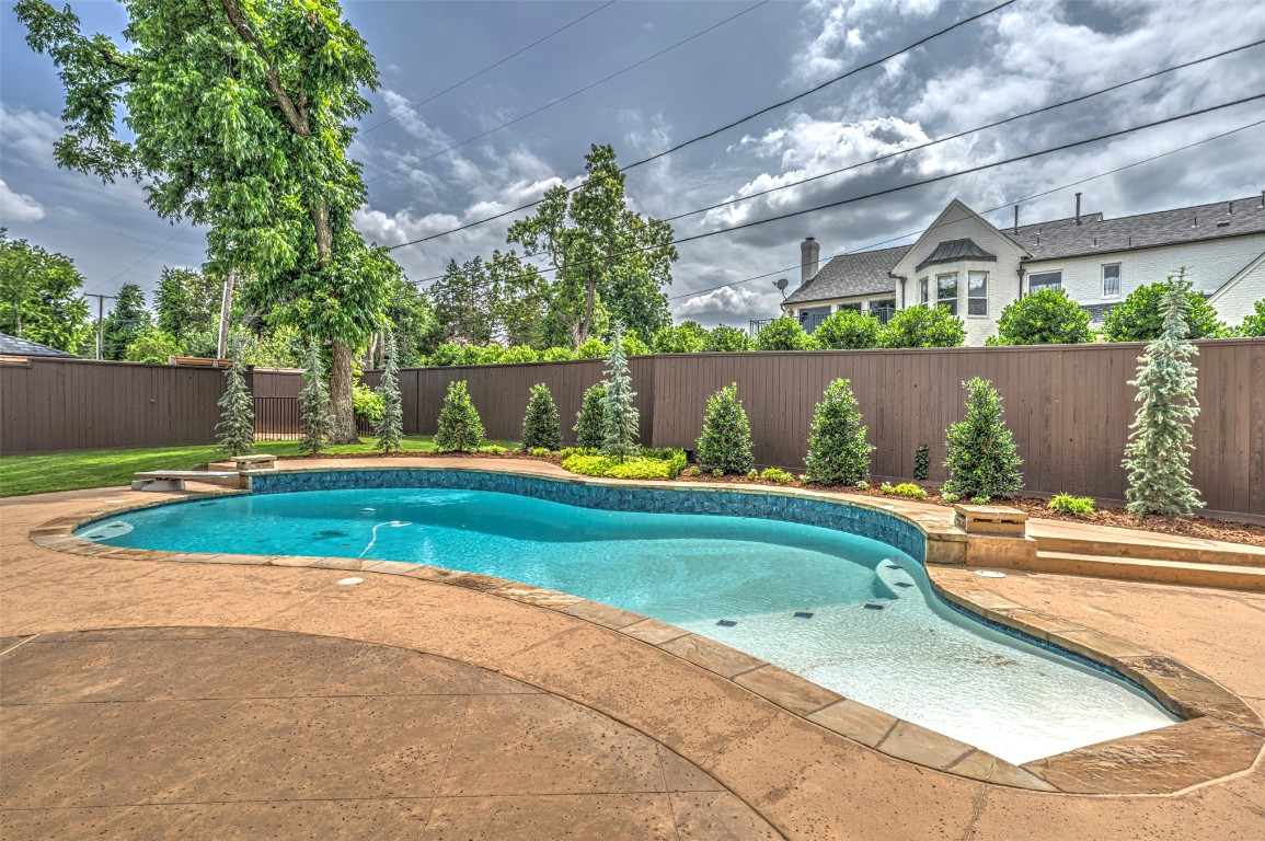 6516 NW Grand Boulevard, Nichols Hills, OK 73116 view of pool featuring a diving board and a patio