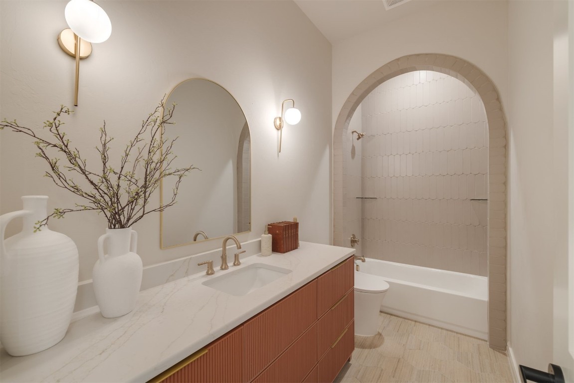 303 E 4th Street, Edmond, OK 73034 full bathroom with tile floors, toilet, shower / bathing tub combination, and vanity