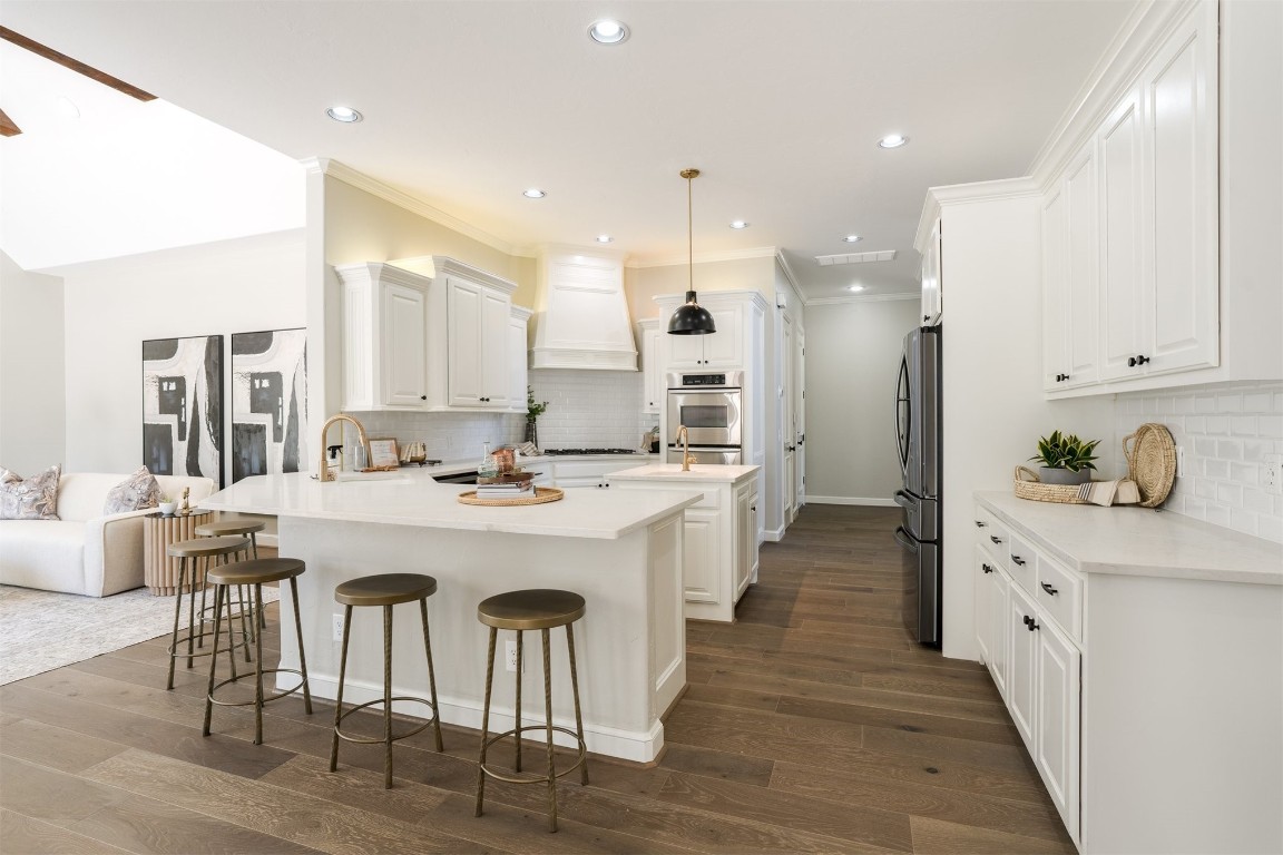3624 Hunters Creek Road, Edmond, OK 73003 kitchen with tasteful backsplash, dark hardwood / wood-style flooring, white cabinets, and premium range hood