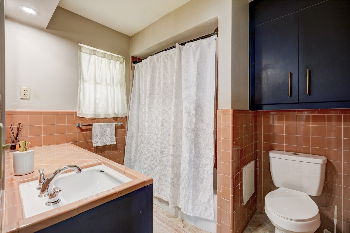 2309 Huntleigh Drive, Oklahoma City, OK 73120 bathroom with tile walls, tasteful backsplash, vanity, and toilet