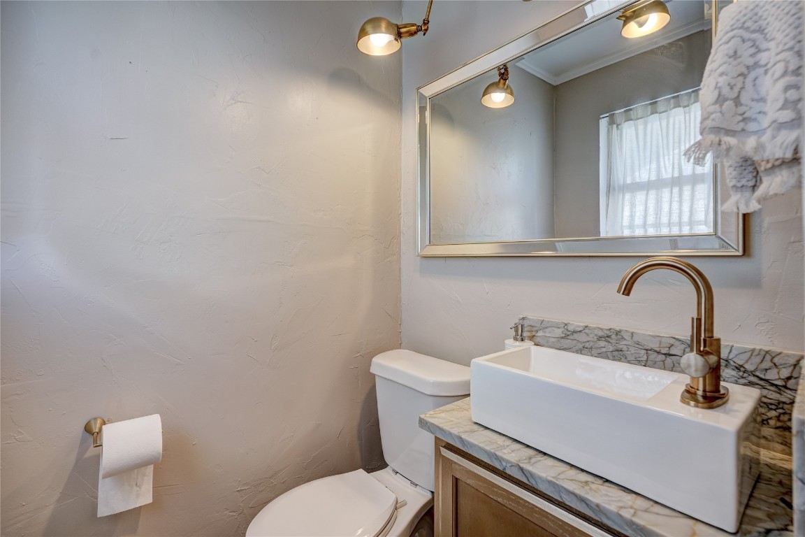 2309 Huntleigh Drive, Oklahoma City, OK 73120 bathroom featuring ornamental molding, vanity, and toilet