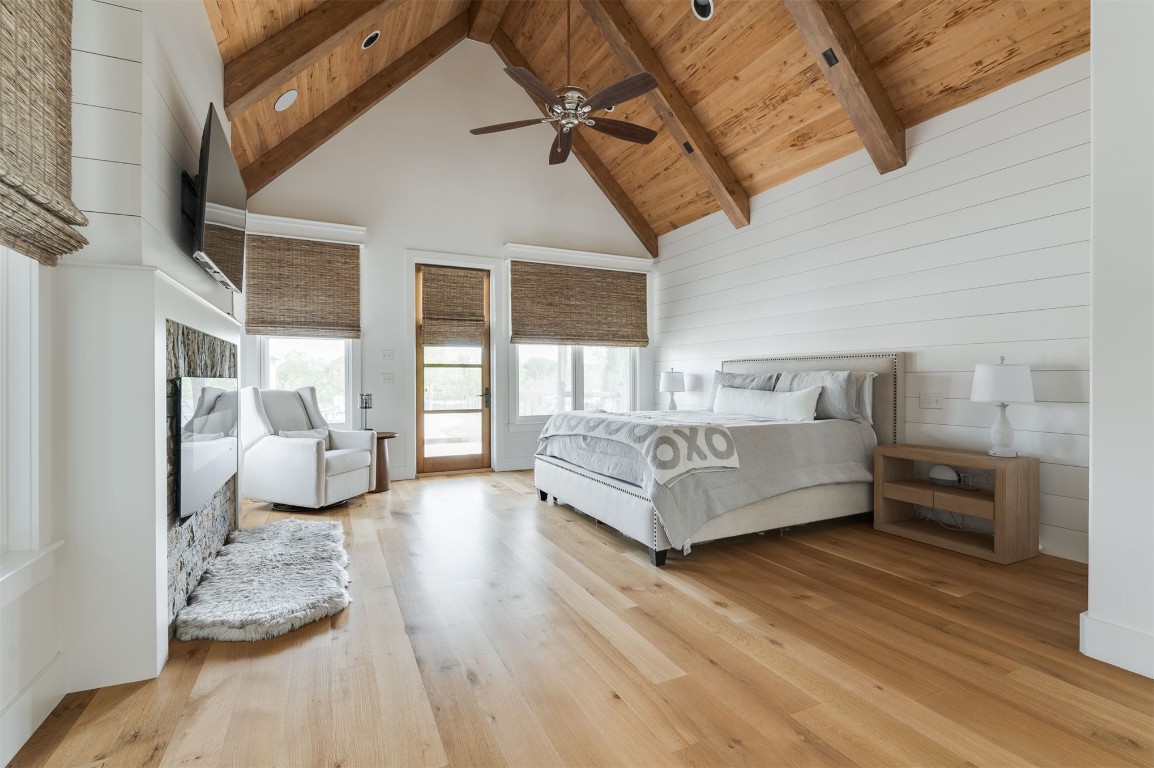 9301 Farmhouse Lane, Arcadia, OK 73007 bedroom featuring wood-type flooring, beamed ceiling, high vaulted ceiling, wooden ceiling, and ceiling fan