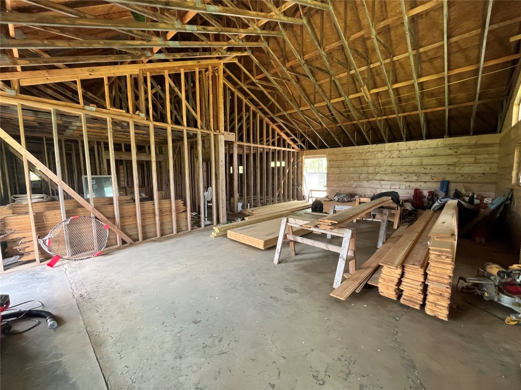 483 Cottontail Trail, Broken Bow, OK 74728 miscellaneous room with vaulted ceiling and concrete flooring
