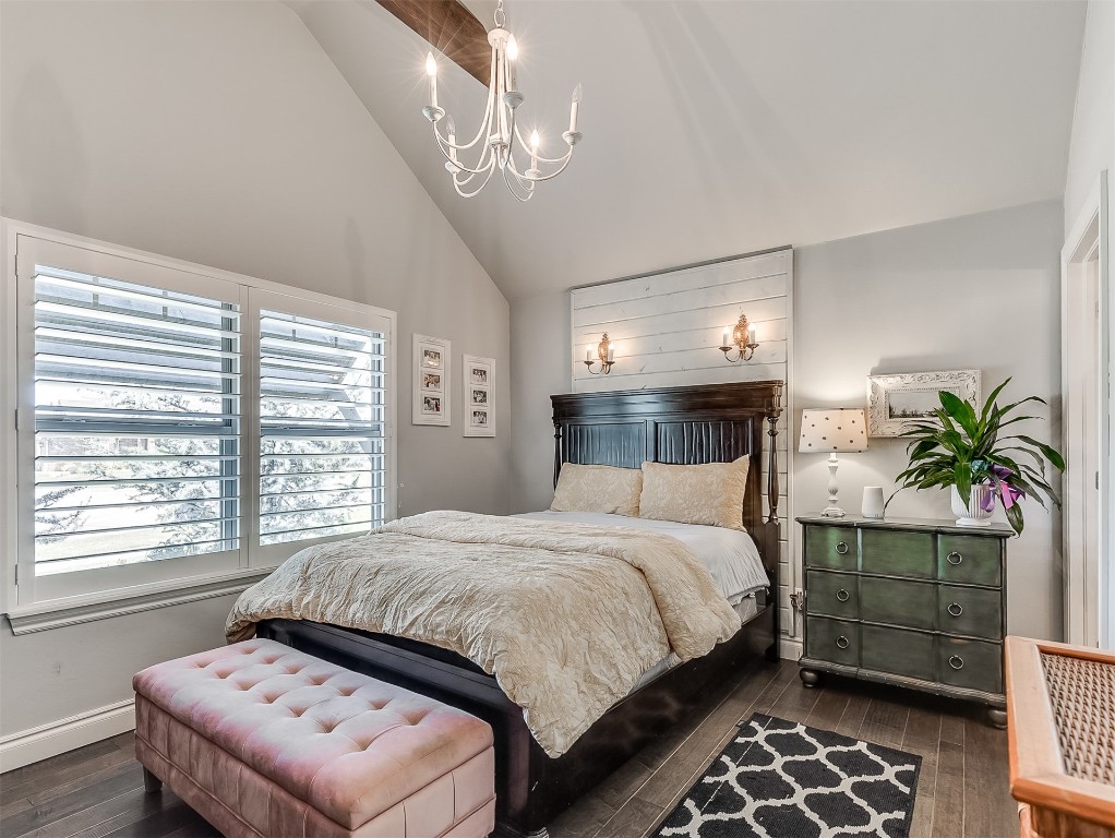 8000 NW 67th Place, Warr Acres, OK 73132 bedroom featuring an inviting chandelier, dark hardwood / wood-style flooring, and high vaulted ceiling