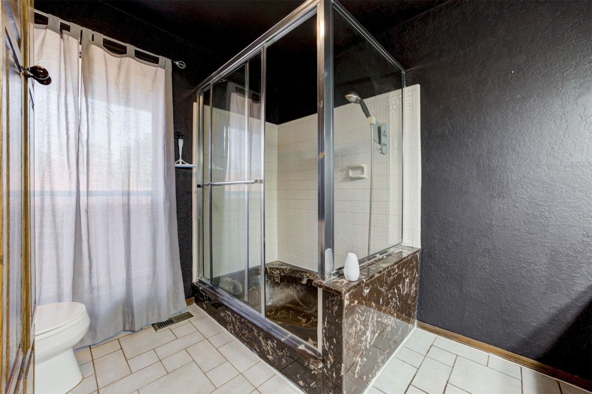 4212 Cherry Hill Lane, Oklahoma City, OK 73120 bathroom with walk in shower, tile floors, and toilet