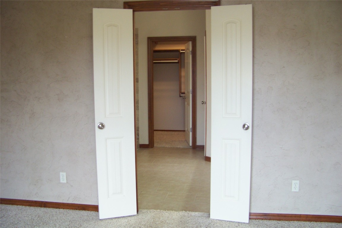 8317 NW 62nd Street, Oklahoma City, OK 73132 corridor featuring carpet flooring