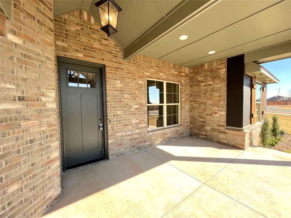 1392 S Gabes Court, Mustang, OK 73064 entrance to property featuring a patio