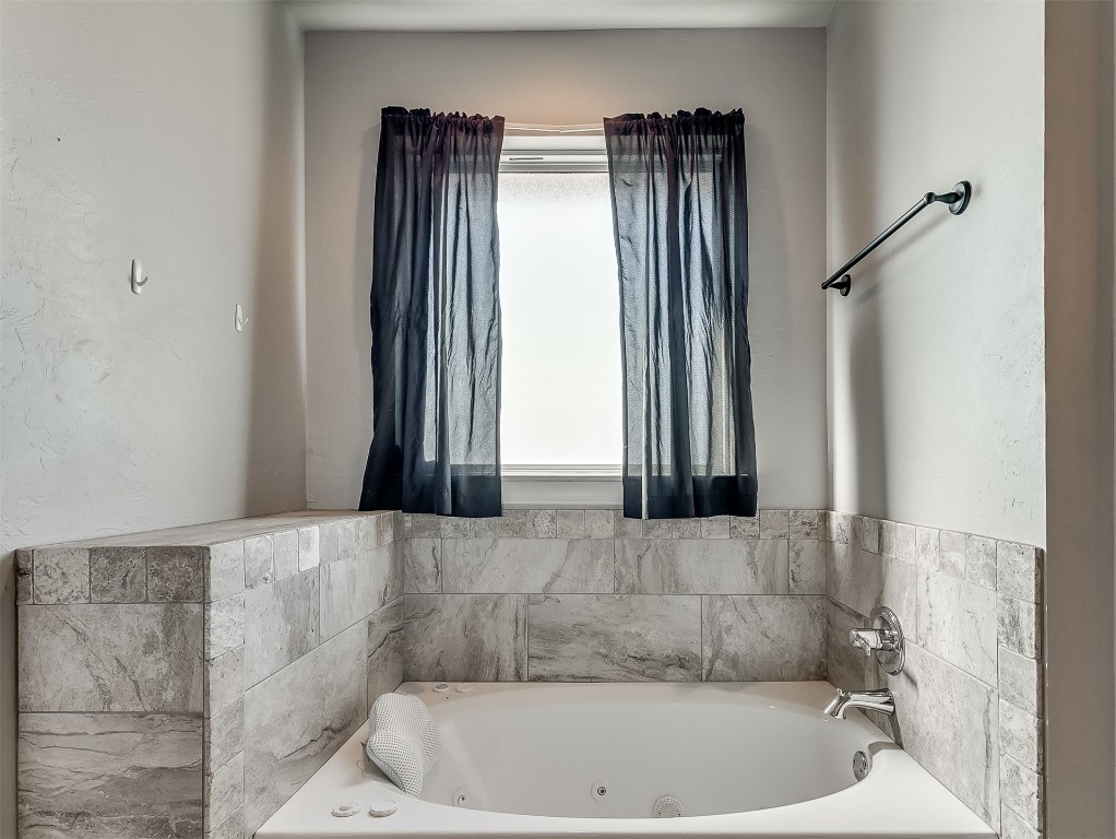 11216 SW 42nd Court, Mustang, OK 73064 bathroom featuring plenty of natural light and a bath to relax in