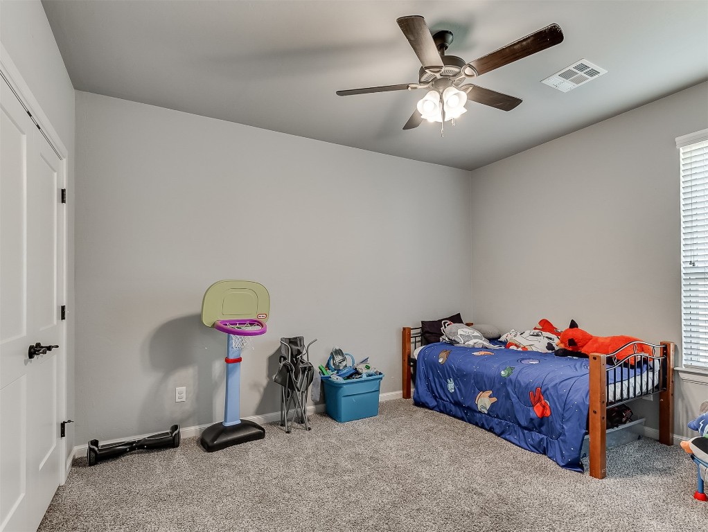 11216 SW 42nd Court, Mustang, OK 73064 bedroom featuring ceiling fan and carpet
