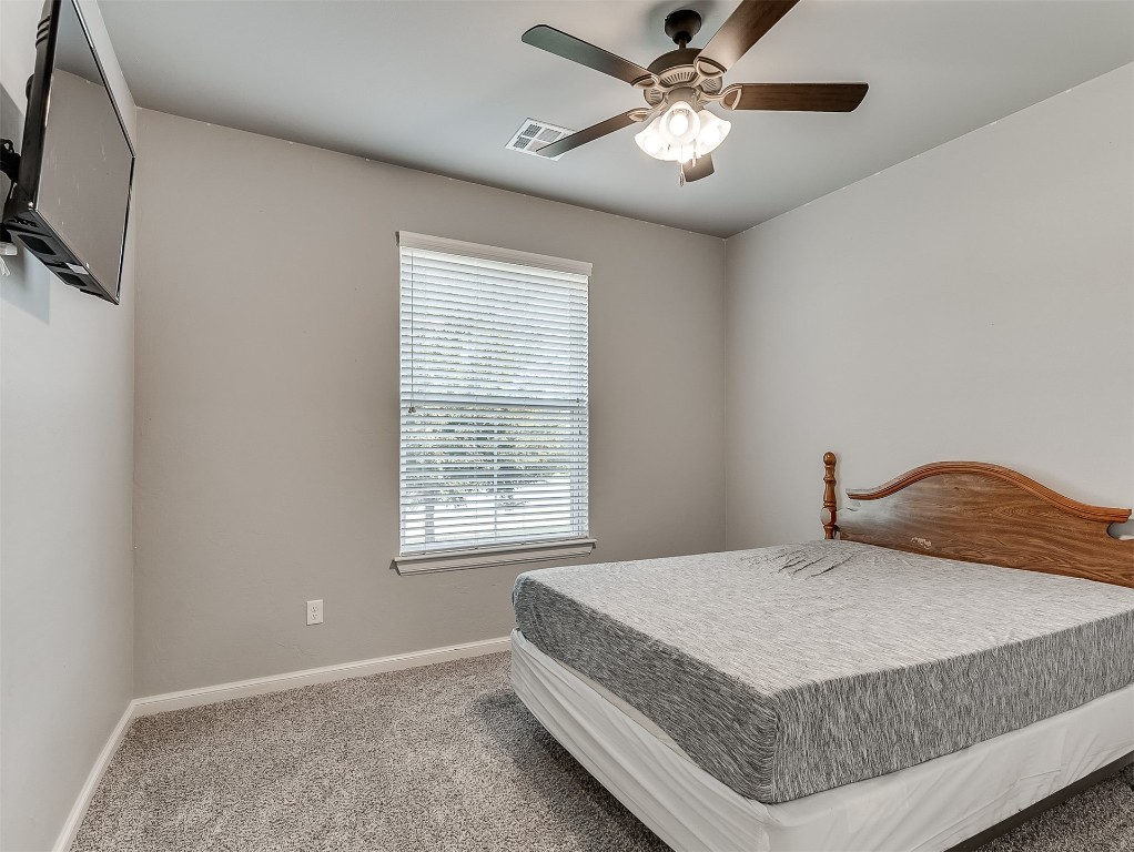 11216 SW 42nd Court, Mustang, OK 73064 carpeted bedroom with ceiling fan