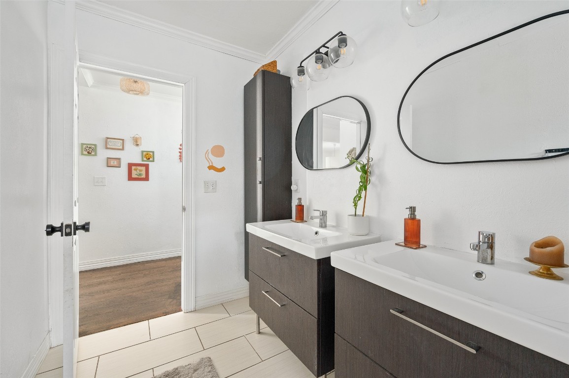 3028 NW 13th Street, Oklahoma City, OK 73107 bathroom featuring oversized vanity, tile floors, dual sinks, and crown molding