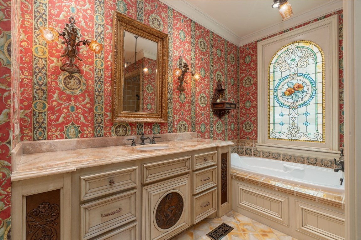 5317 Wisteria Drive, Oklahoma City, OK 73142 bathroom with a tub, oversized vanity, ornamental molding, and tile flooring