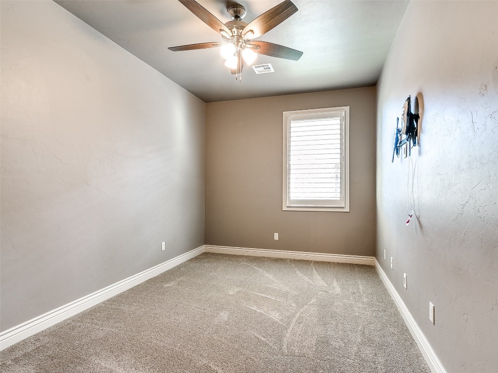 15820 Rockwell Park Lane, Edmond, OK 73013 carpeted spare room featuring ceiling fan