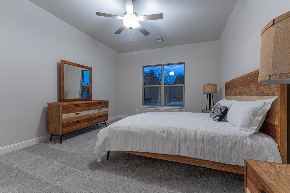 9016 NE 141st Street, Jones, OK 73049 carpeted bedroom featuring ceiling fan