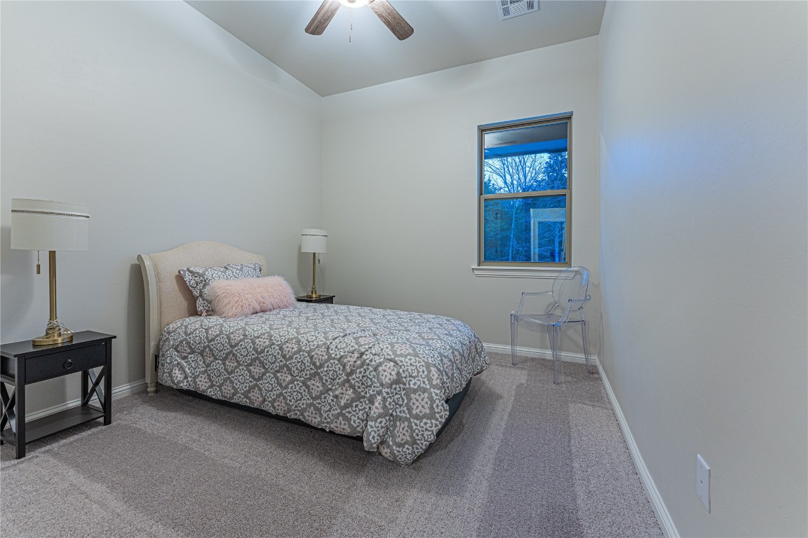 9016 NE 141st Street, Jones, OK 73049 bedroom featuring ceiling fan and carpet flooring