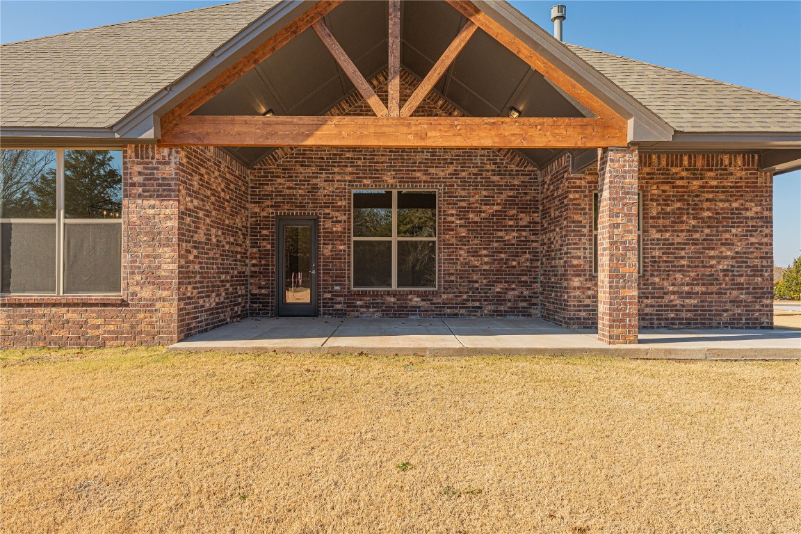 9016 NE 141st Street, Jones, OK 73049 back of property with a patio area and a yard