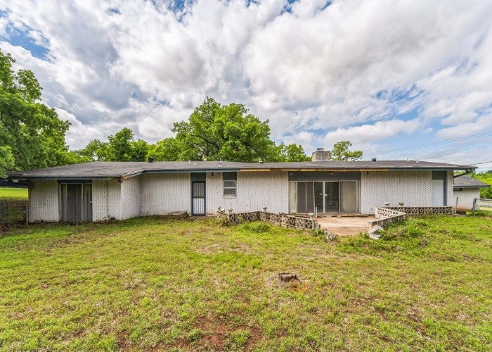 Opportunity awaits in this mid century three bedroom, two bath brick home. Work is required to make this home move in ready but could be worth the effort. Bring your design ideas and make this home your own!
