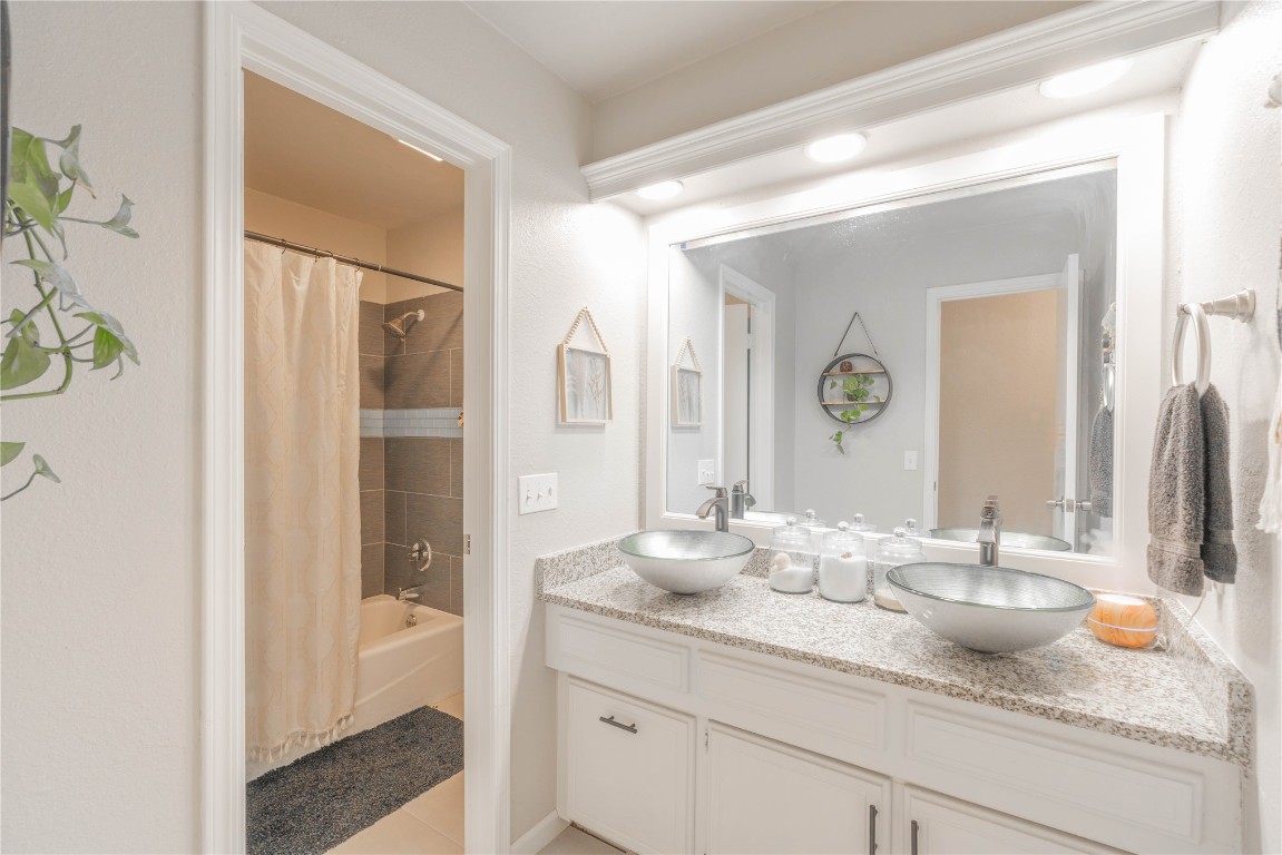 5217 NW 109th Street, Oklahoma City, OK 73162 bathroom featuring tile flooring, vanity, and shower / bath combo