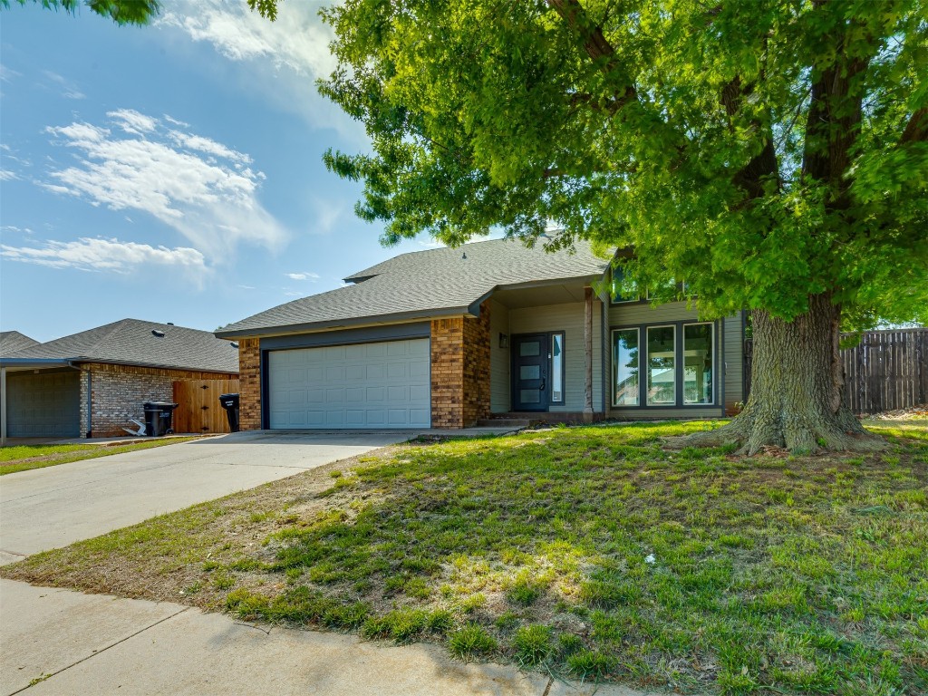 604 Fire Light Drive, Moore, OK 73160 ranch-style house featuring a garage and a front lawn