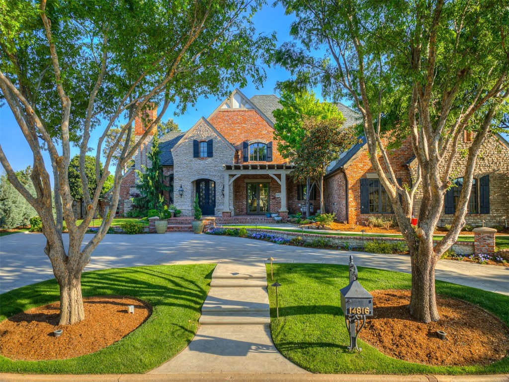 14816 Aurea Lane, Oklahoma City, OK 73142 tudor-style house with a front lawn