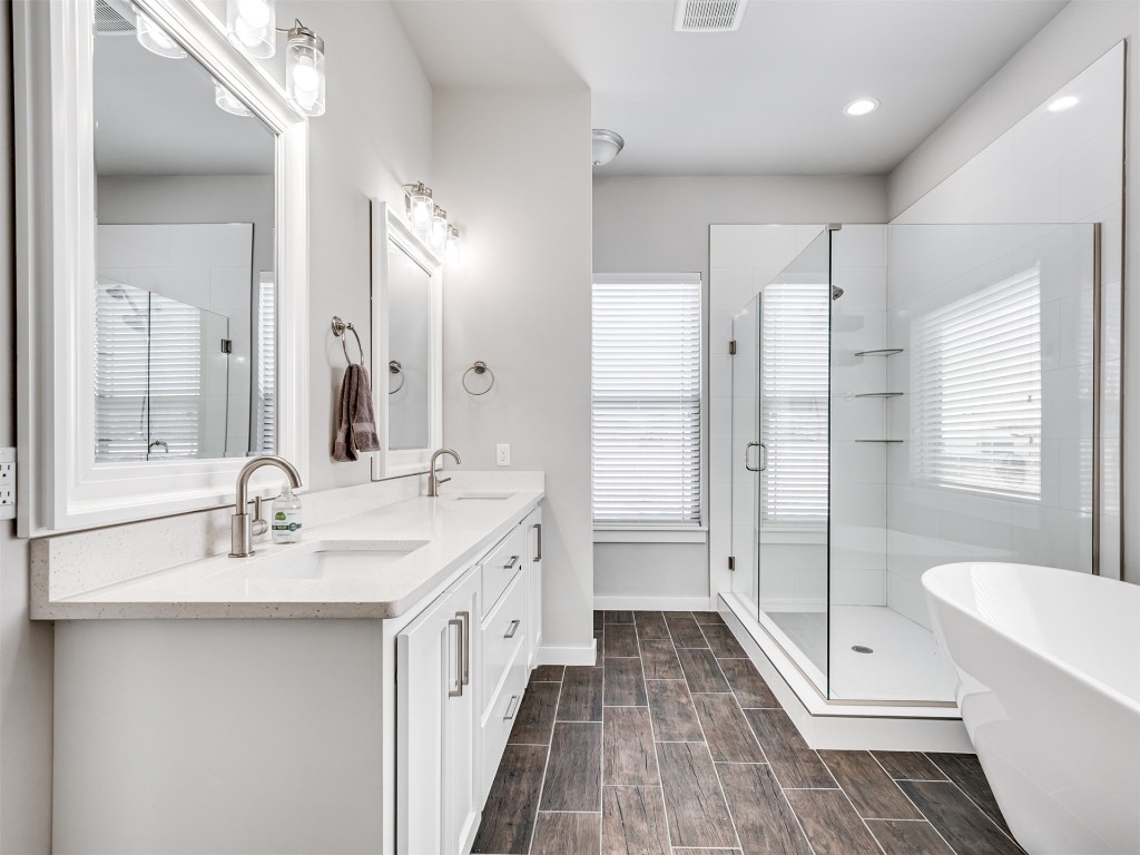 515 Isabella Drive, Blanchard, OK 73010 bathroom featuring hardwood / wood-style flooring, dual bowl vanity, and plus walk in shower