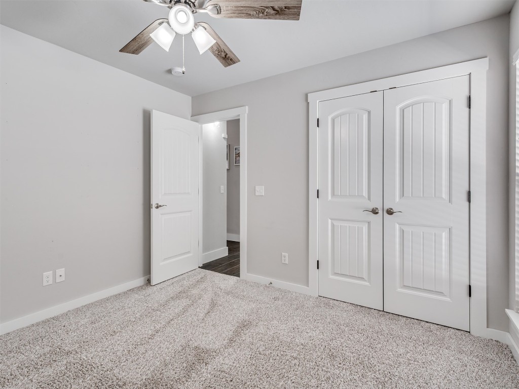 515 Isabella Drive, Blanchard, OK 73010 unfurnished bedroom with a closet, ceiling fan, and carpet floors