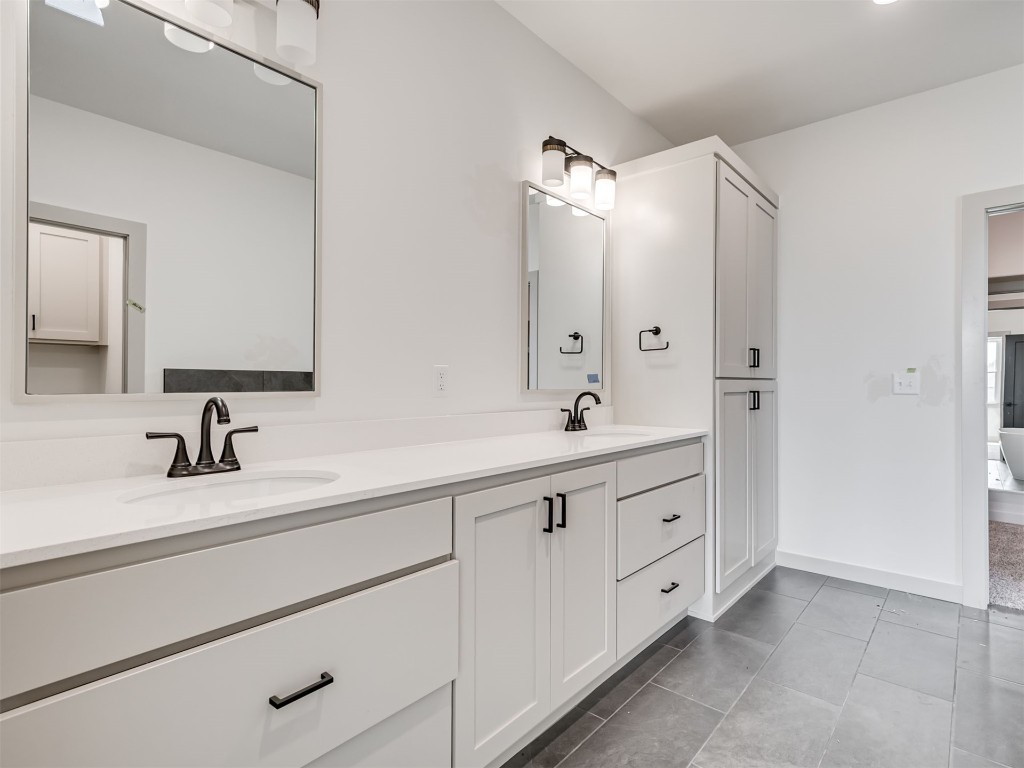 118 NE Primrose Point Avenue, Piedmont, OK 73128 bathroom featuring dual bowl vanity and tile flooring