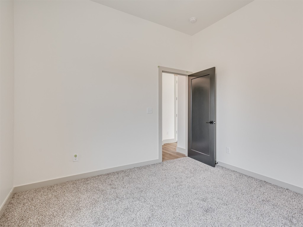 118 NE Primrose Point Avenue, Piedmont, OK 73128 unfurnished room featuring carpet