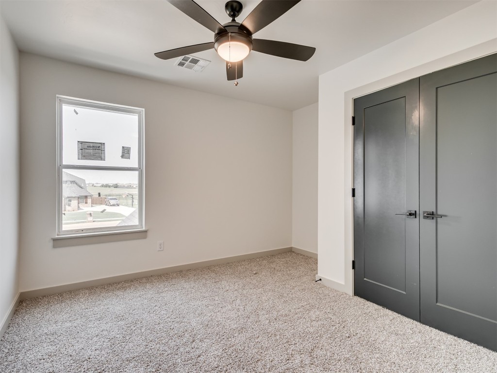 118 NE Primrose Point Avenue, Piedmont, OK 73128 interior space featuring a closet, light carpet, and ceiling fan