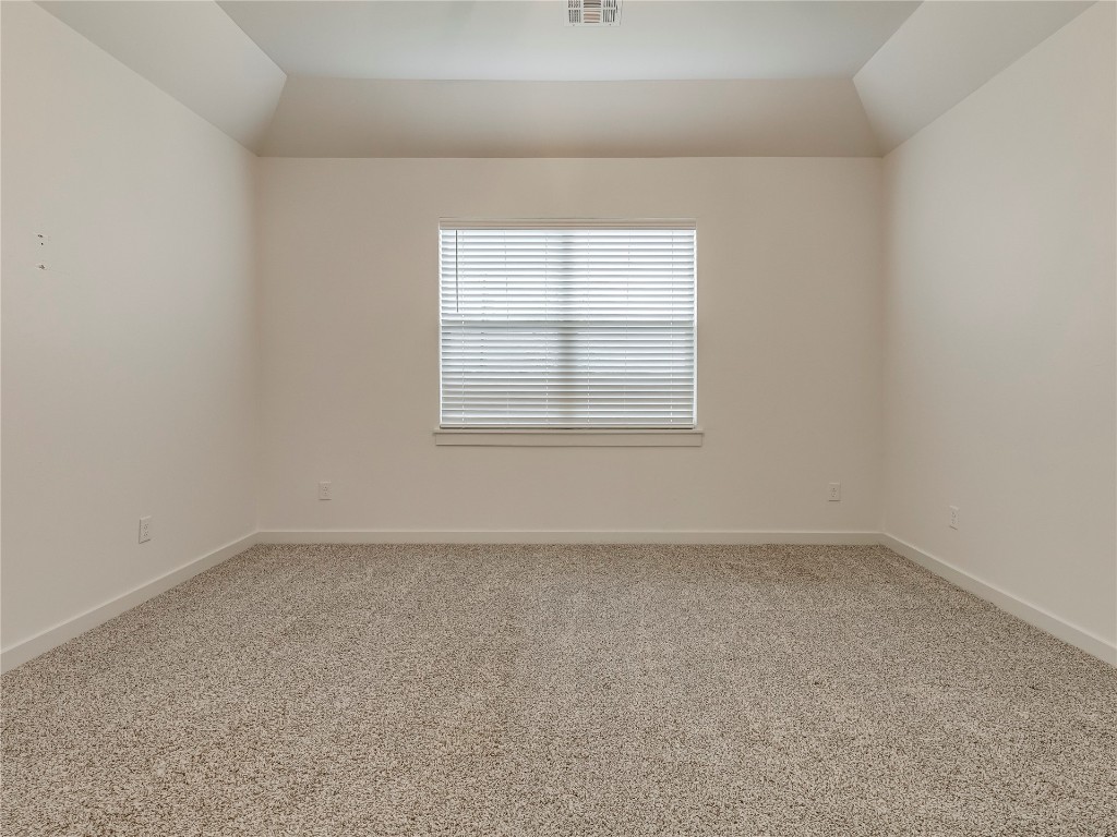 143 Primrose Point Avenue, Piedmont, OK 73078 unfurnished room with light colored carpet and vaulted ceiling