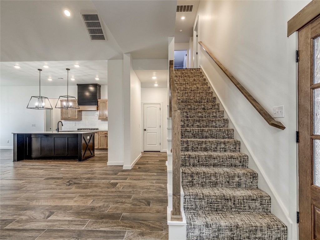 143 Primrose Point Avenue, Piedmont, OK 73078 stairway featuring dark hardwood / wood-style flooring and sink