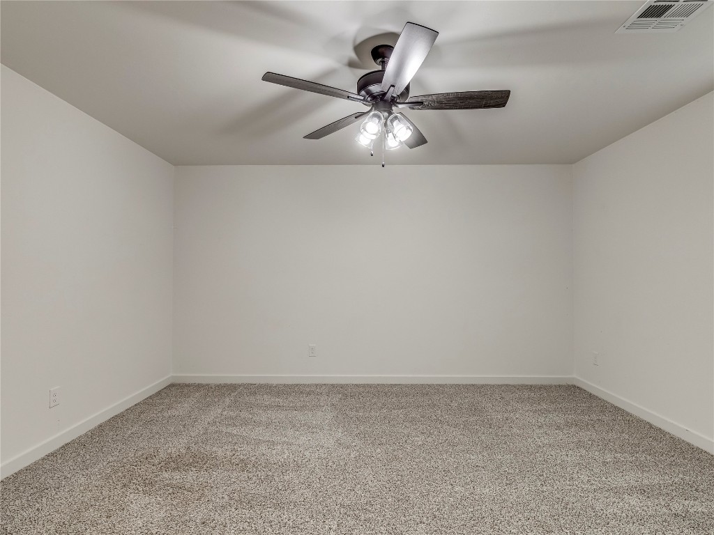 143 Primrose Point Avenue, Piedmont, OK 73078 empty room featuring light carpet and ceiling fan