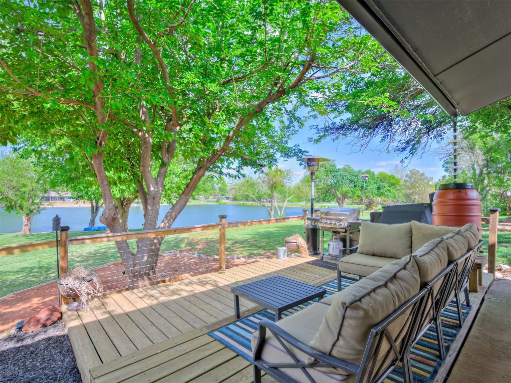 9625 Ritter Road, Oklahoma City, OK 73162 deck with an outdoor living space, a boat dock, and a water view
