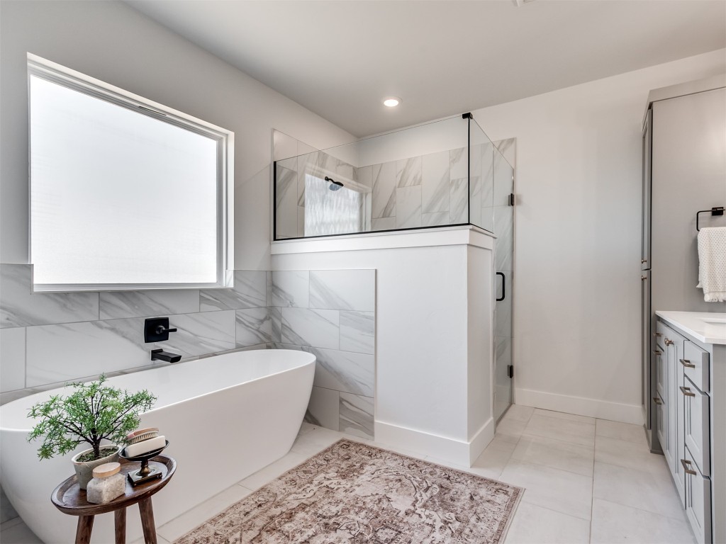446 Venetian Avenue, Piedmont, OK 73078 bathroom with vanity, shower with separate bathtub, tile floors, and tile walls