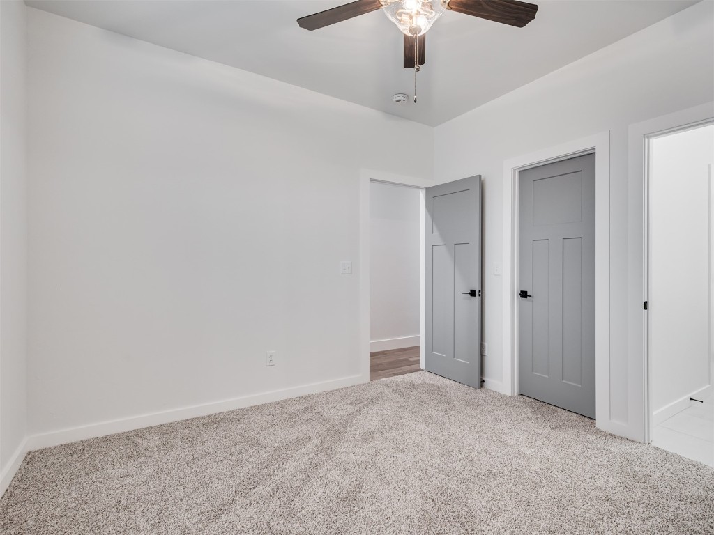 446 Venetian Avenue, Piedmont, OK 73078 unfurnished bedroom with light colored carpet and ceiling fan