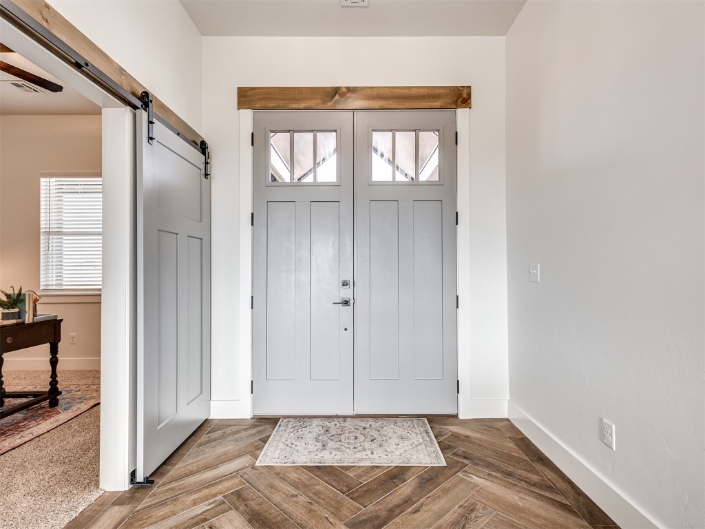 446 Venetian Avenue, Piedmont, OK 73078 foyer featuring a barn door and parquet floors