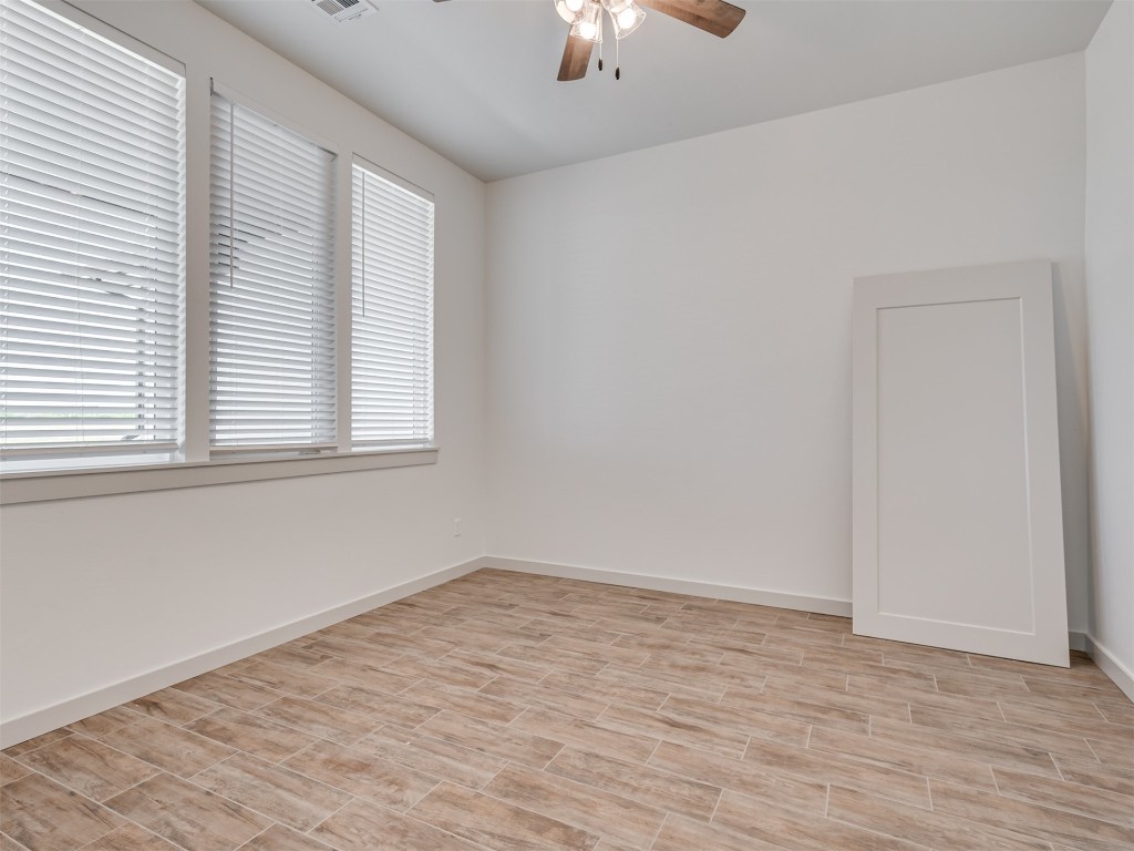 508 Venetian Avenue, Piedmont, OK 73078 unfurnished bedroom featuring light colored carpet, ceiling fan, ensuite bathroom, and a closet